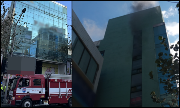 23일 대구 동구 신천동 한 건물의 4층 성인 무도장에서 화재가 발생해 창문 밖으로 검은 연기가 피어오르고 있다. 대구소방본부 제공